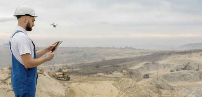 Operator flying a DR2000 drone for mercury sampling at a mine site
